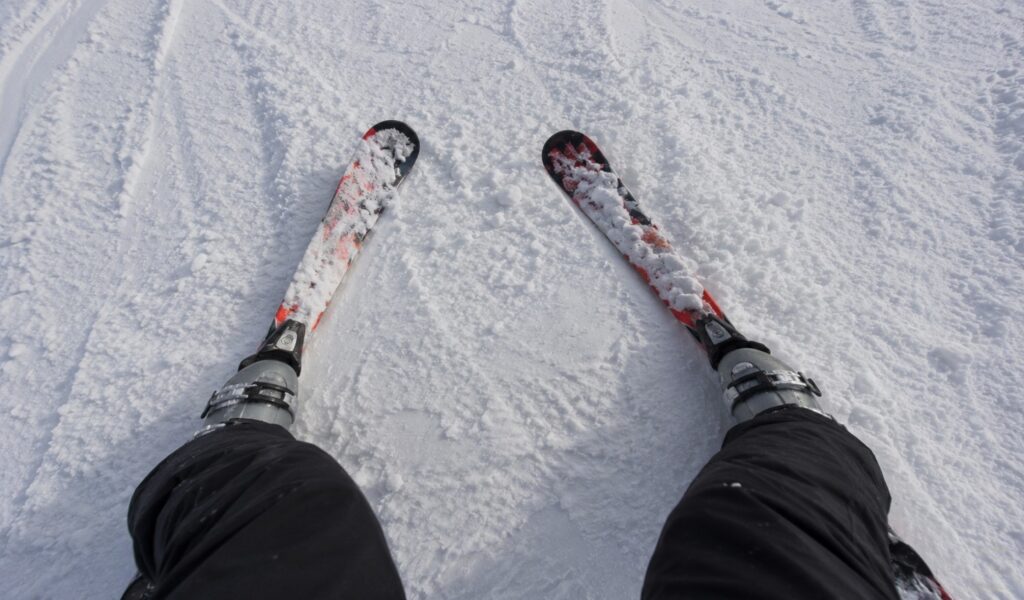Beginner skier mastering the snowplough stance