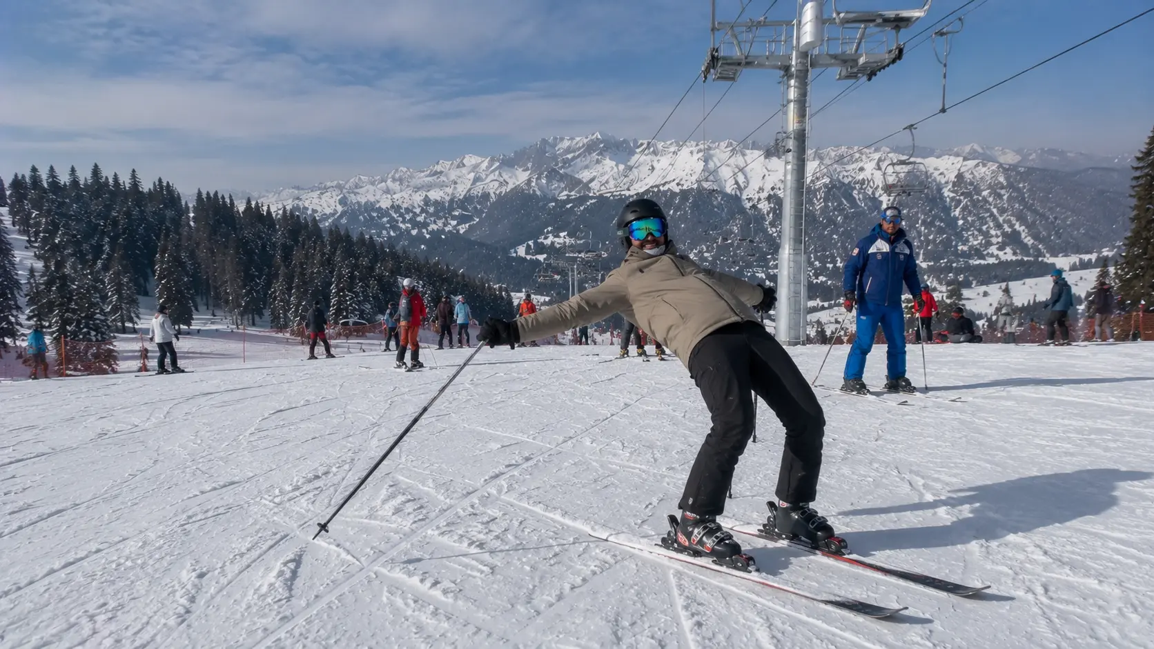 A beginner skier struggling with backseat stance on a nursery slope