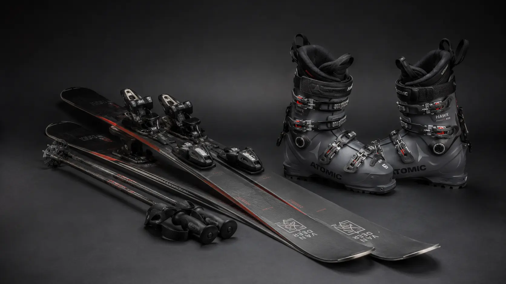 Essential skiing equipment including skis, boots, bindings, and poles for beginners