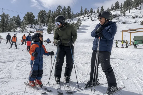 Three generations of a family enjoying a skiing holiday in India