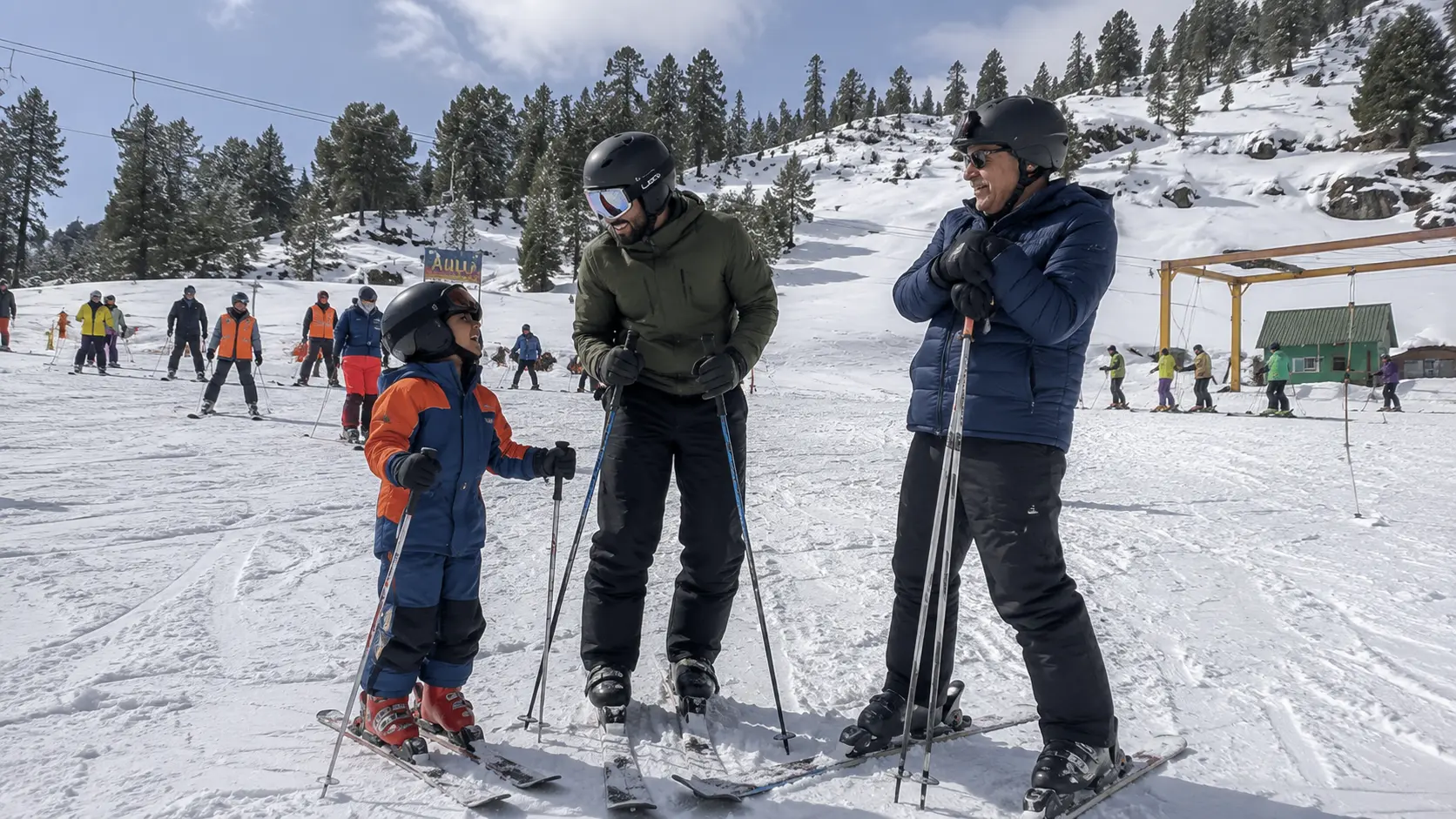 Three generations of a family enjoying a skiing holiday in India