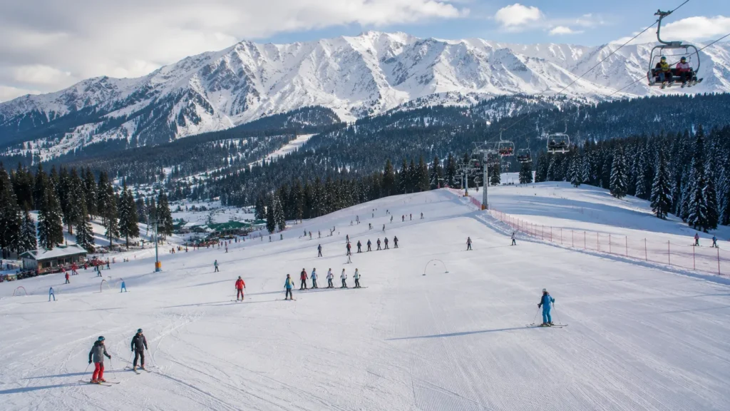Groomed green ski slopes and ski lifts for beginners in the Indian Himalayas