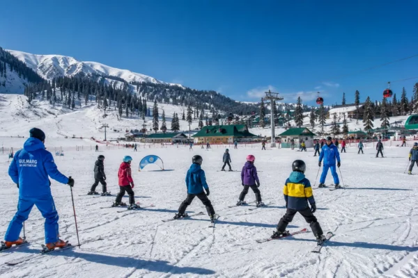 Beginner skiers practicing group lessons on the wide nursery slopes of Gulmarg Kashmir