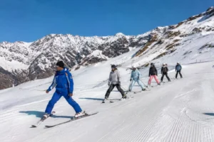 A certified ski instructor guiding students on the slopes in India