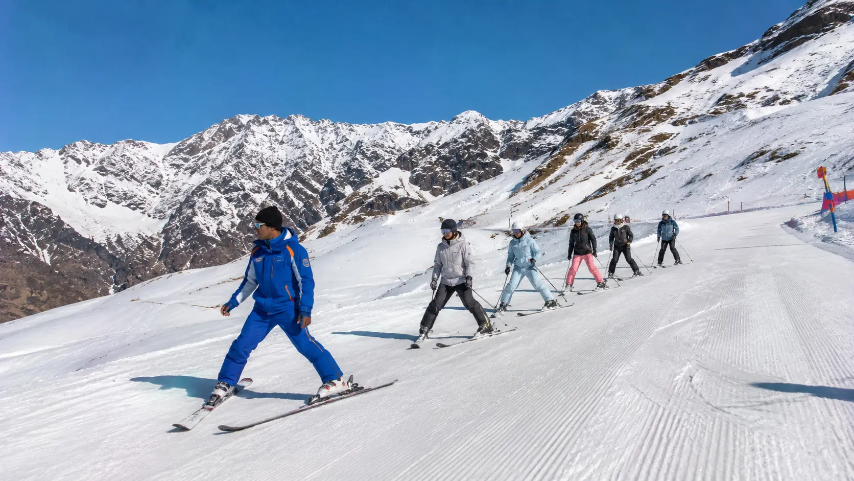 A certified ski instructor guiding students on the slopes in India